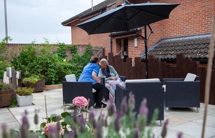 Resident And Staff Member In The Garden at Friars Mead, Kings Langley WD4 8DR