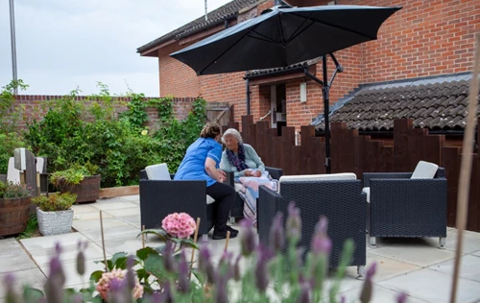 Resident And Staff Member In The Garden at Friars Mead, Kings Langley WD4 8DR