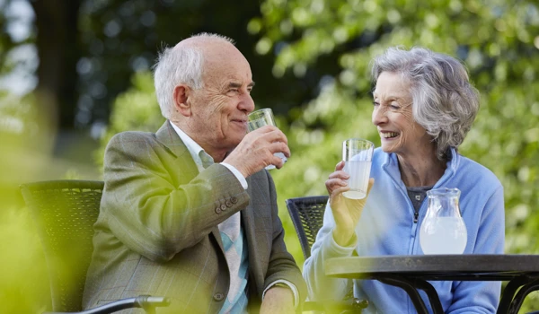 Older Couple Enjoying Drinks Outdoors