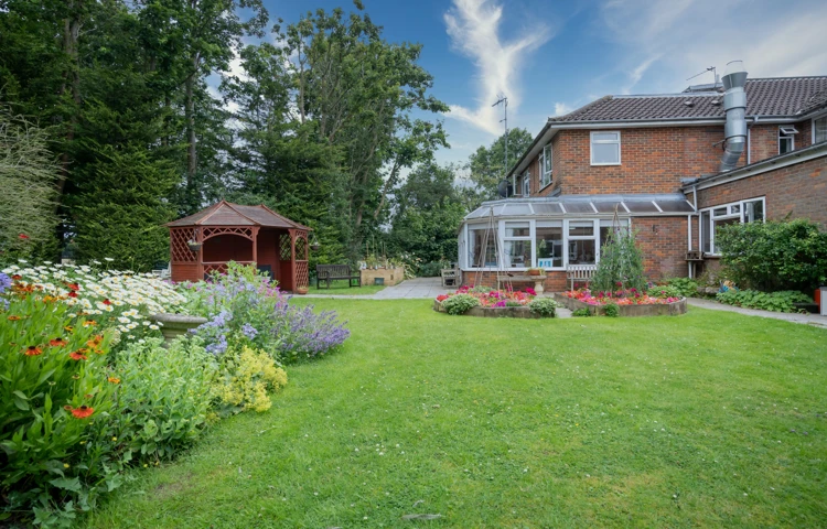 External view of Pratt House garden and pergola and flowers