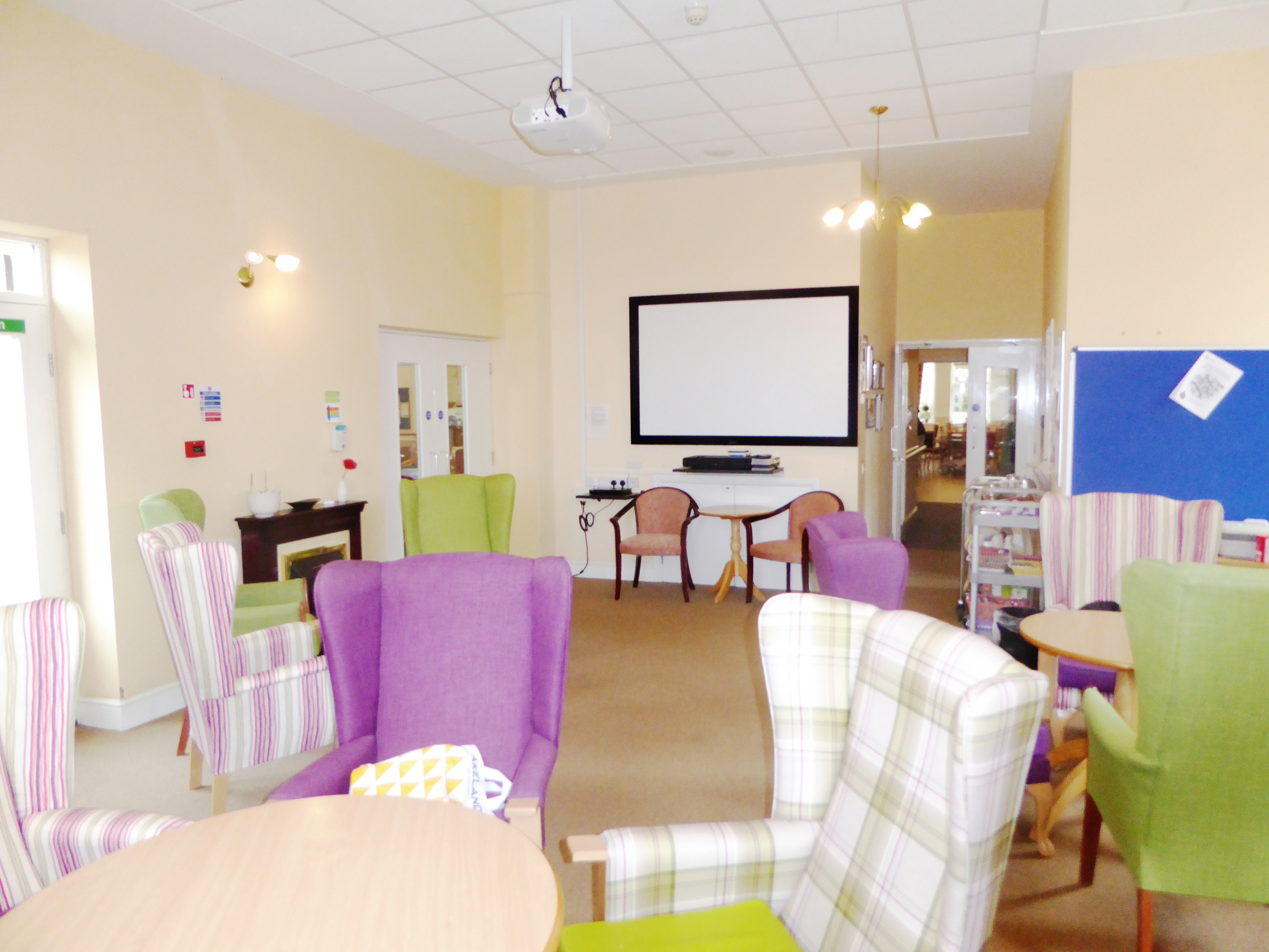 Large bright dining area with coloured chairs