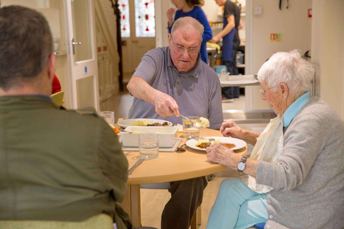 Residents eating in the dining room ar Abbeyfield House, Hove BN3 4GB