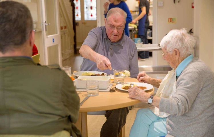 Residents eating in the dining room ar Abbeyfield House, Hove BN3 4GB