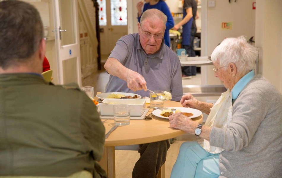 Residents eating in the dining room ar Abbeyfield House, Hove BN3 4GB