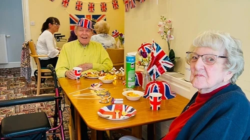 Residents sat at a table with union jack decorations