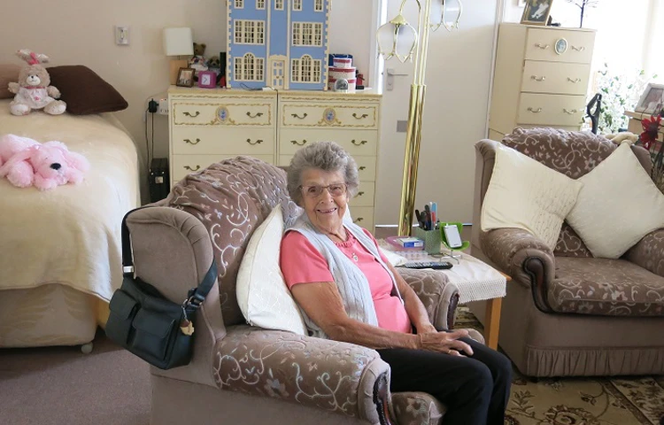 Resident enjoys sitting in her bedroom at Harding House