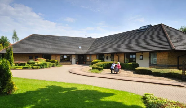 Caste Farm on a sunny day a resident staff sat outside