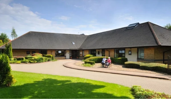 Caste Farm on a sunny day a resident staff sat outside