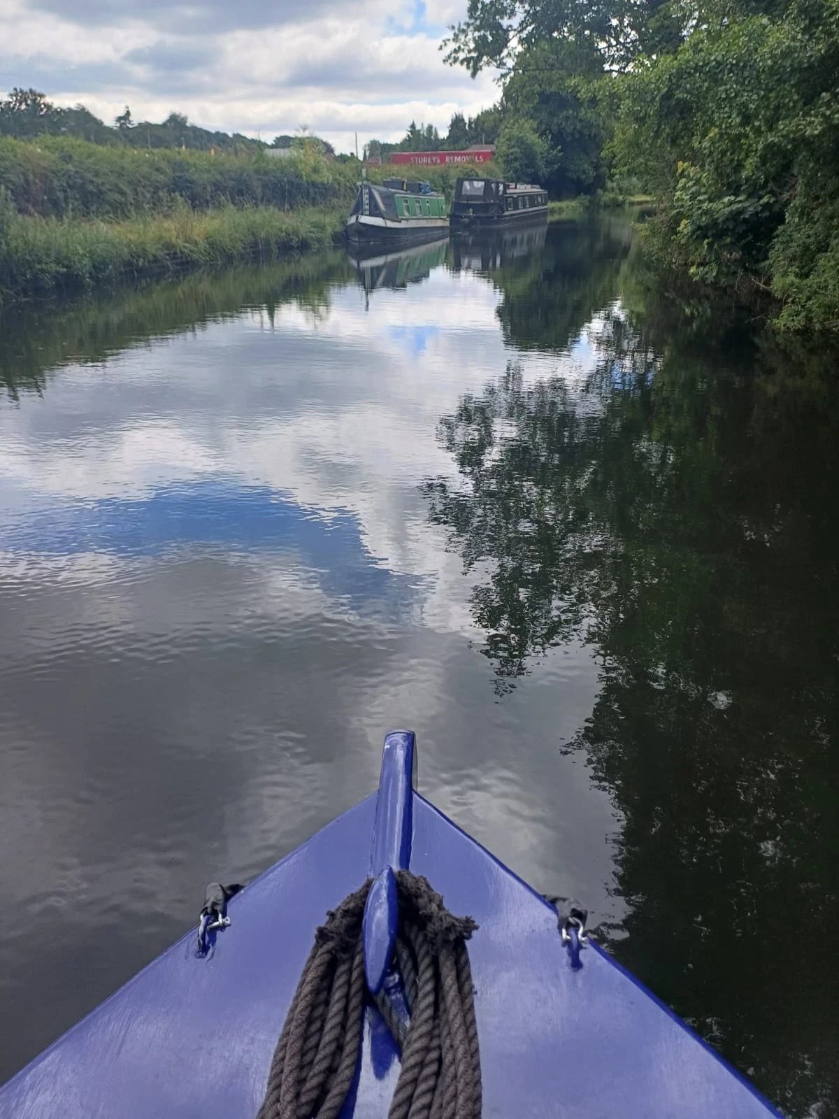 A view of the water from the front of the canal boat