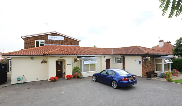 Front exterior of Abbeyfield House, Basildon with car parking in the front of the house