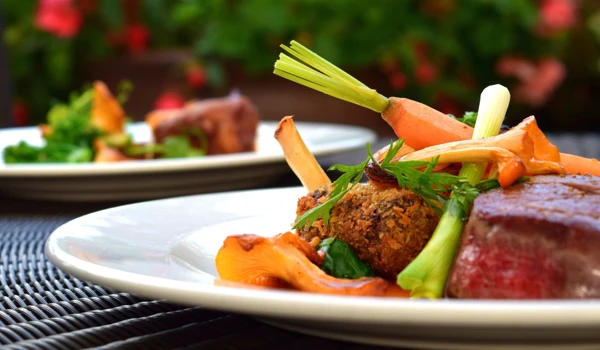 Healthy Dinner Of Steak And Vegetables On Outdoor Table