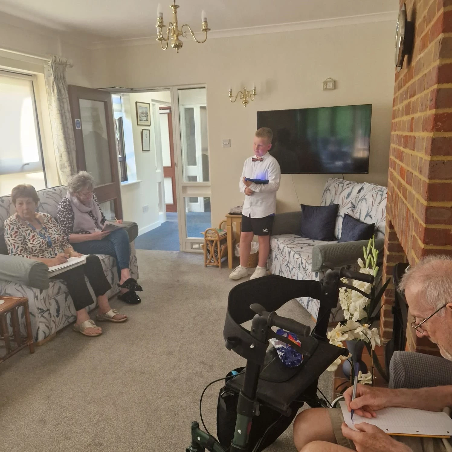 A child running a quiz for residents