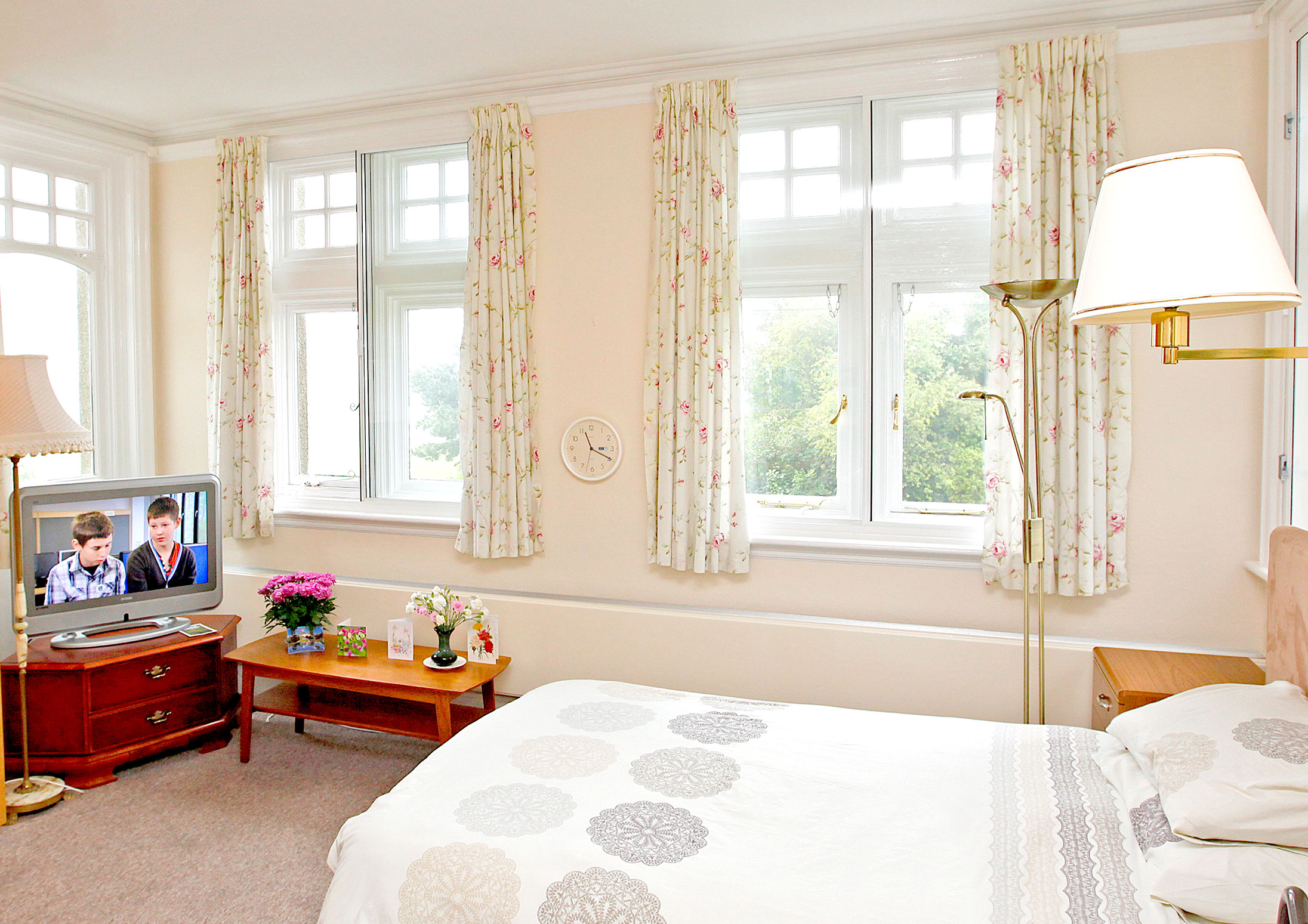 Bedroom with large windows at Abbeyfield Hill House