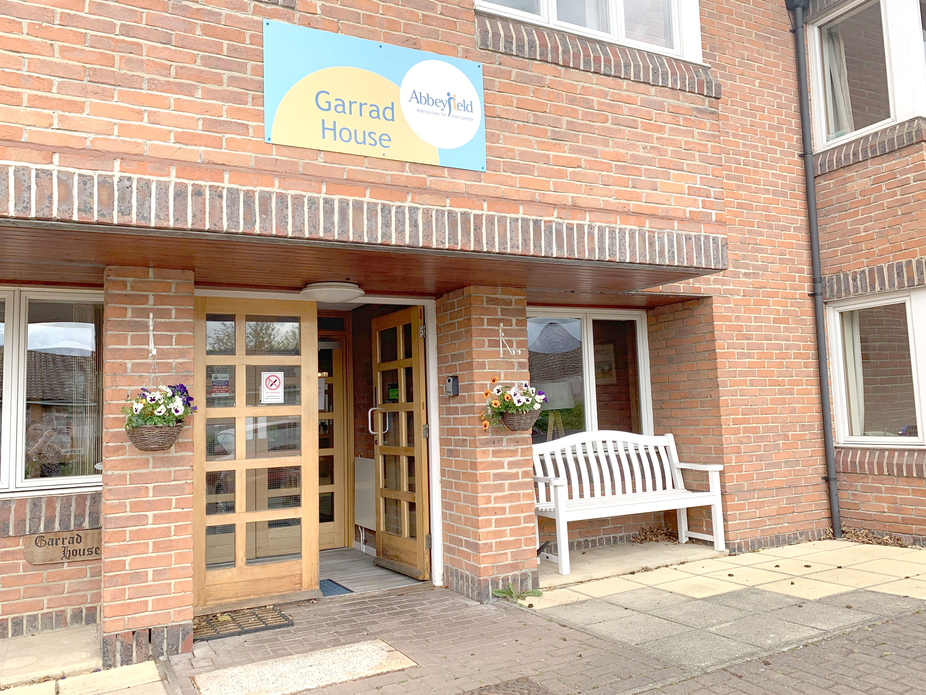 Front exterior of Garrad House with bench outside