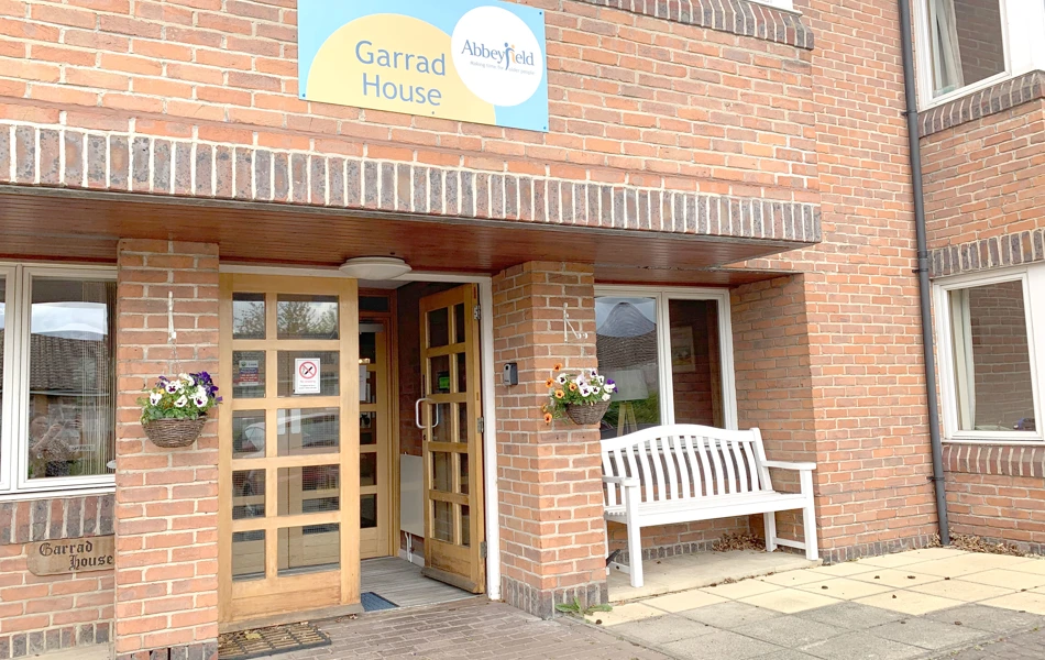 Front exterior of Garrad House with bench outside