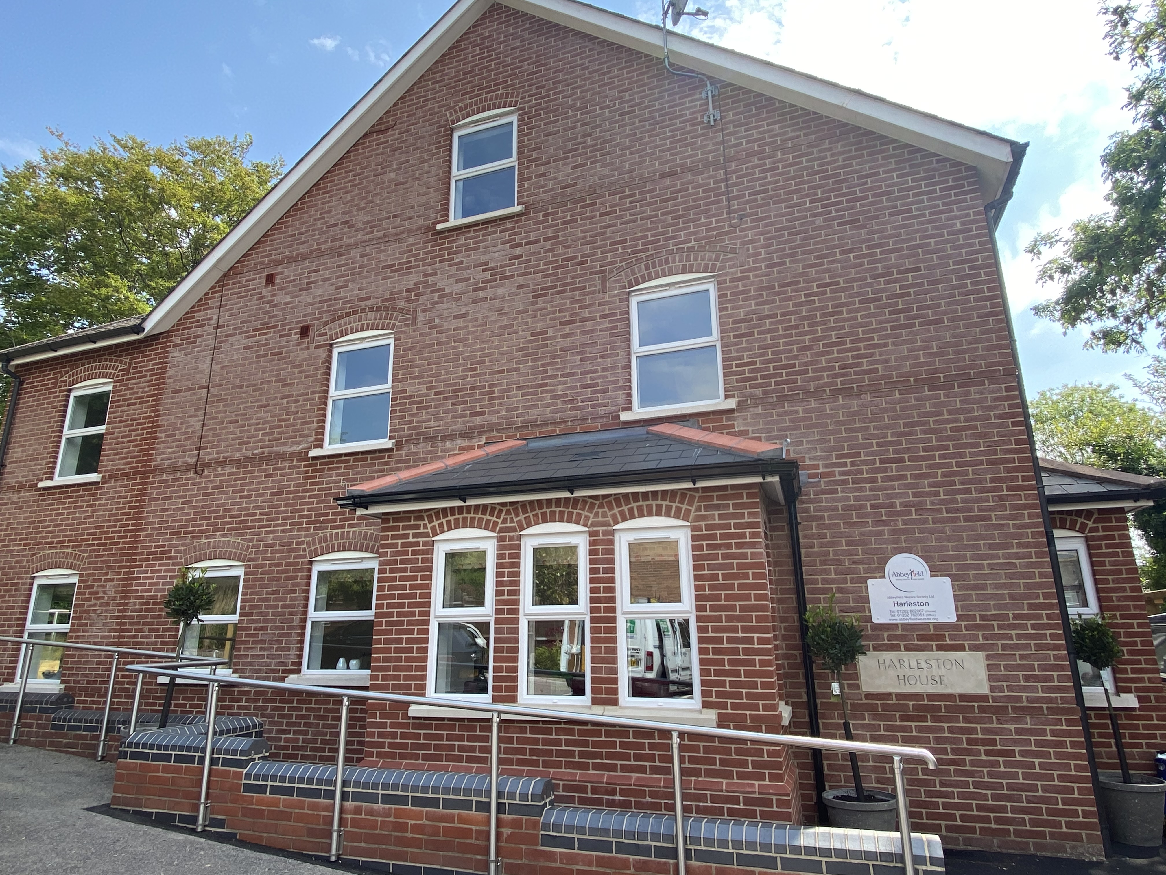 The outside of the house with a handrail for support