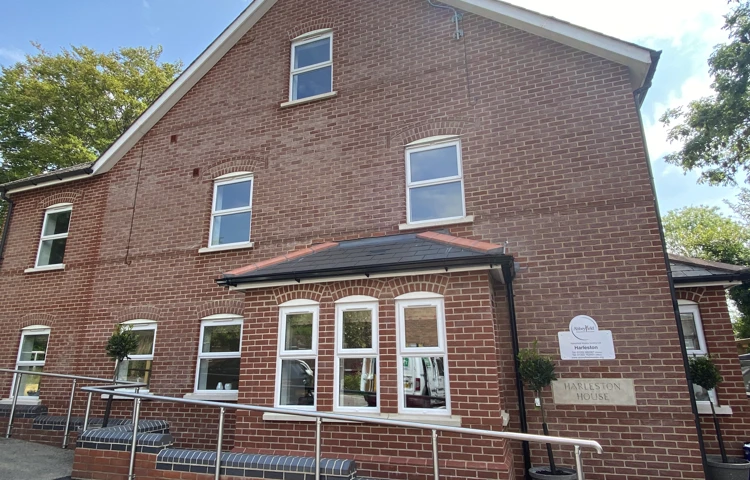 The outside of the house with a handrail for support