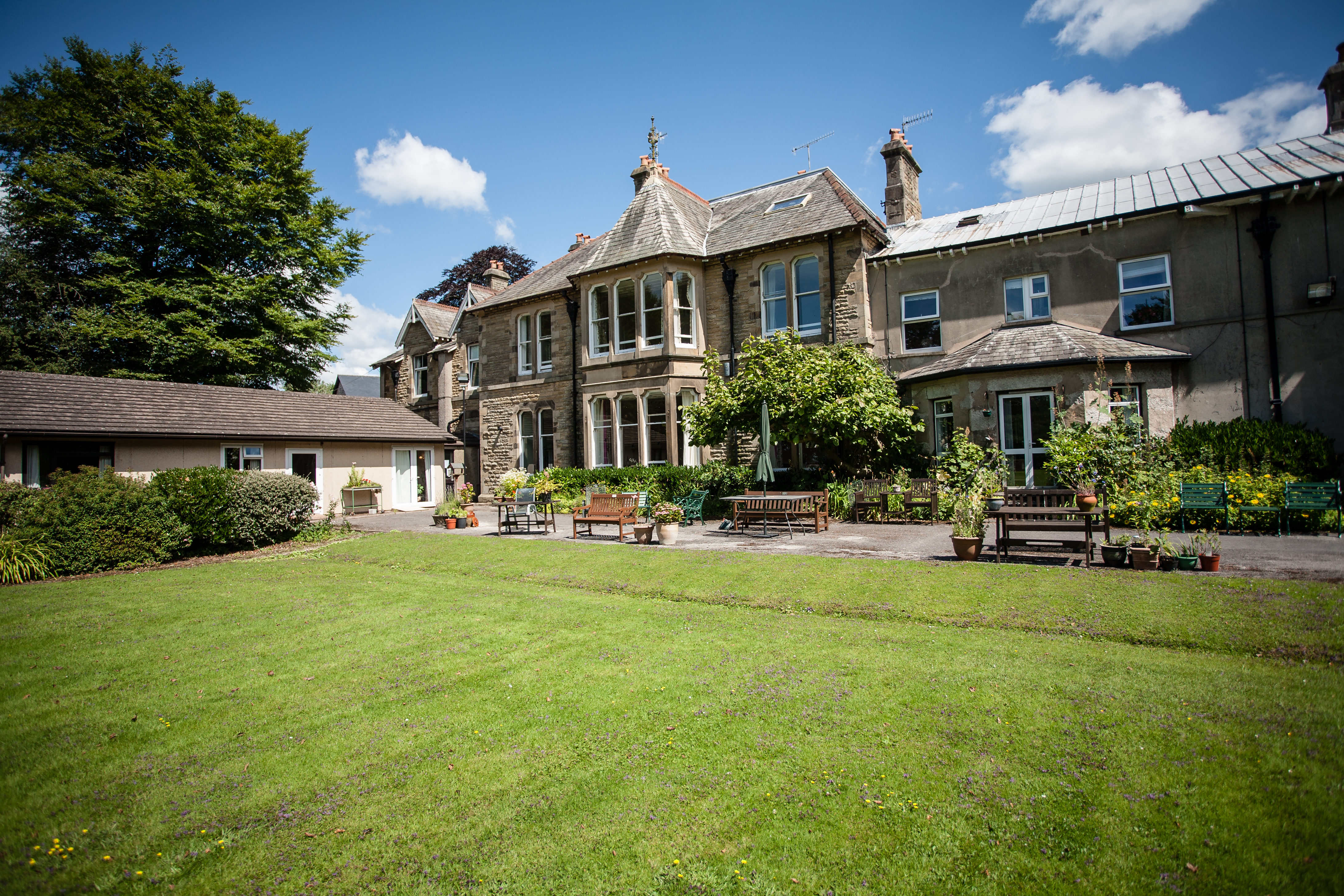 A bright lawn and seating area outside Cove House